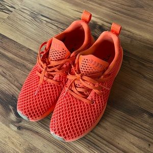 Nobull orange running shoe.